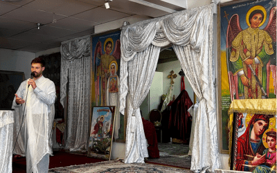 Calum Samuelson giving a presentation in an Ethiopian church setting