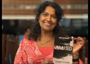 Usha Reifsnider holding copy of Unmuted
